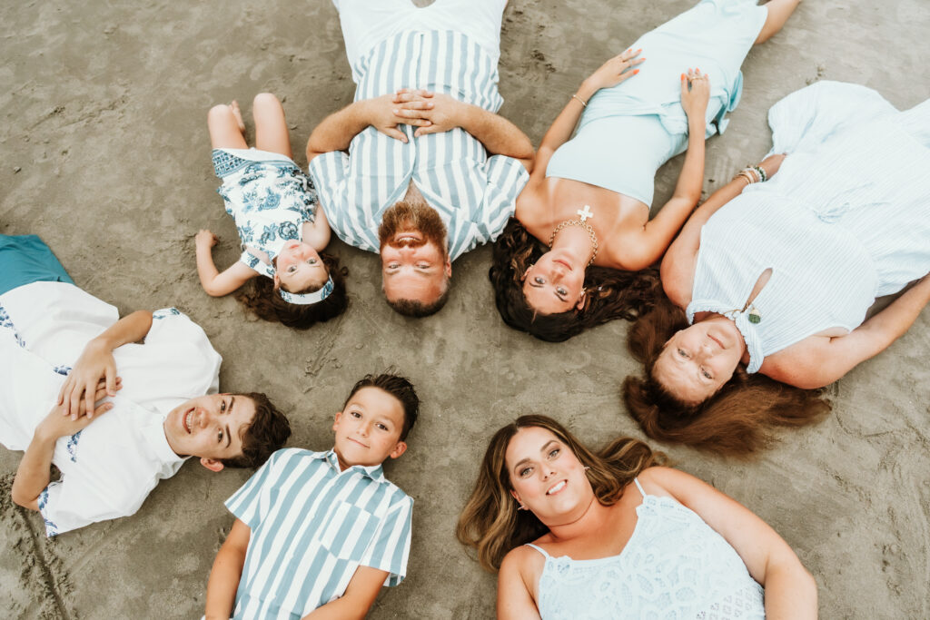 family hugging together during sunset beach photos in Myrtle Beach South Carolina