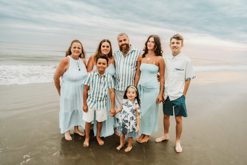 family walking along the shoreline during a sunset session in Myrtle Beach South Carolina